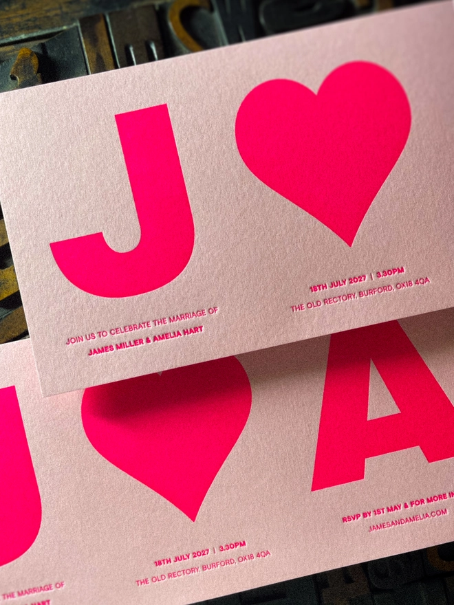 Luxury personalised letterpress wedding invitation from the Amour collection, featuring bold initials and heart in fluorescent pink ink on Candy Pink GF Smith Colorplan card.