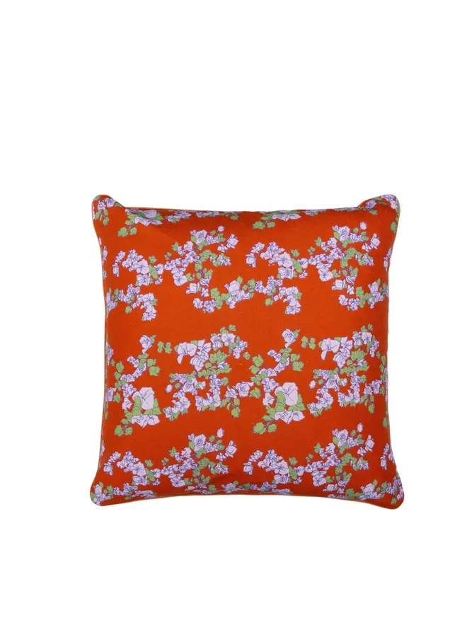 red floral cushion on blank background