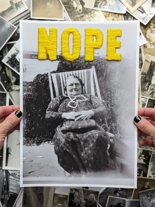  B & W photo print of woman with yellow embroidered ‘nope’ held against vintage photos