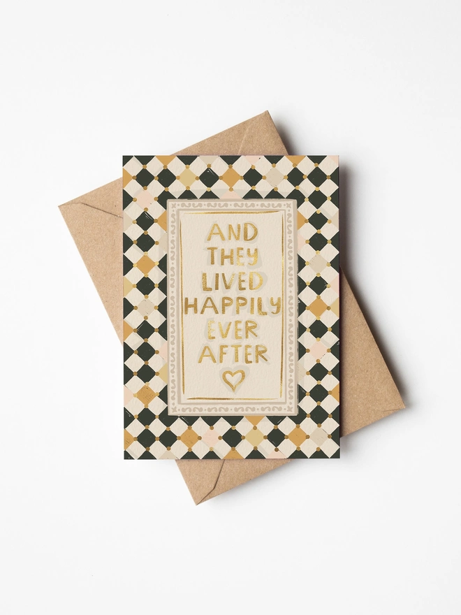 And they lived happily ever after message in gold foil with checkerboard background