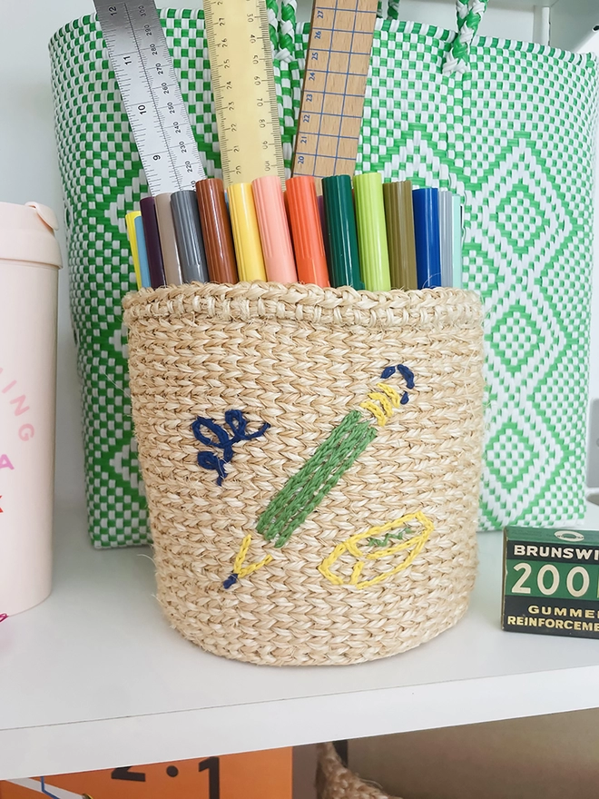 pencil motif basket displayed on a shelf