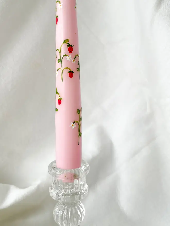 Wild Strawberry Pink Hand Painted Candle, a pink candle in a glass vase sitting against a white backdrop. 
