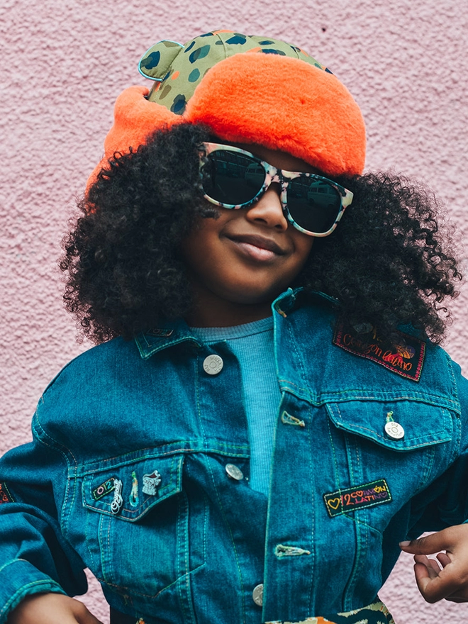 Girl wearing winter neutral leopard trapper hat