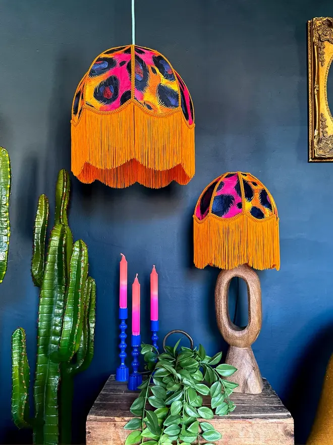 Vintage Fringed Dome Lampshade In Electric Leopard, in a room. 