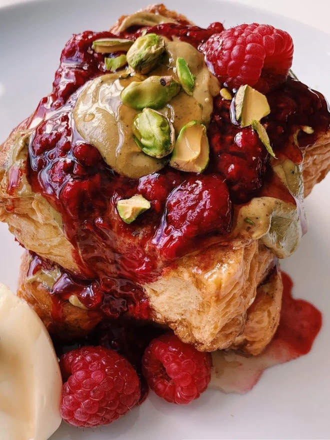 rose and pistachio butter. a piece of toast topped with jam and rose pistachio butter.