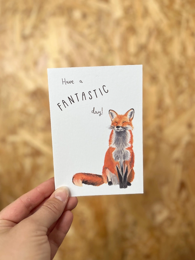 Greetings card with a happy looking red fox and the phrase ‘have a fantastic day”