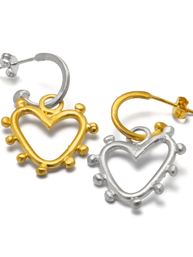 Bold yet beautifully balanced, the Belong Together Hoop Earrings pair classic hoops with mixed metal studded heart charms for a contemporary finish. Lightweight and full of movement, these heart hoop earrings are made for everyday styling — a timeless statement piece designed to celebrate love, individuality and modern elegance.