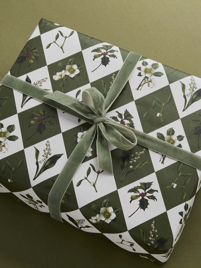 green and ivory harlequin pattern with festive botanicals wrapping paper