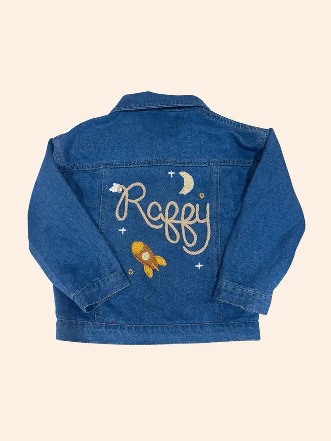 Hand-embroidered denim jacket with rocket, moon and clouds