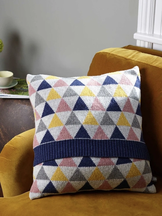Lambswool Patterned Cushion, a cushion sitting on a yellow chair in a living room. 