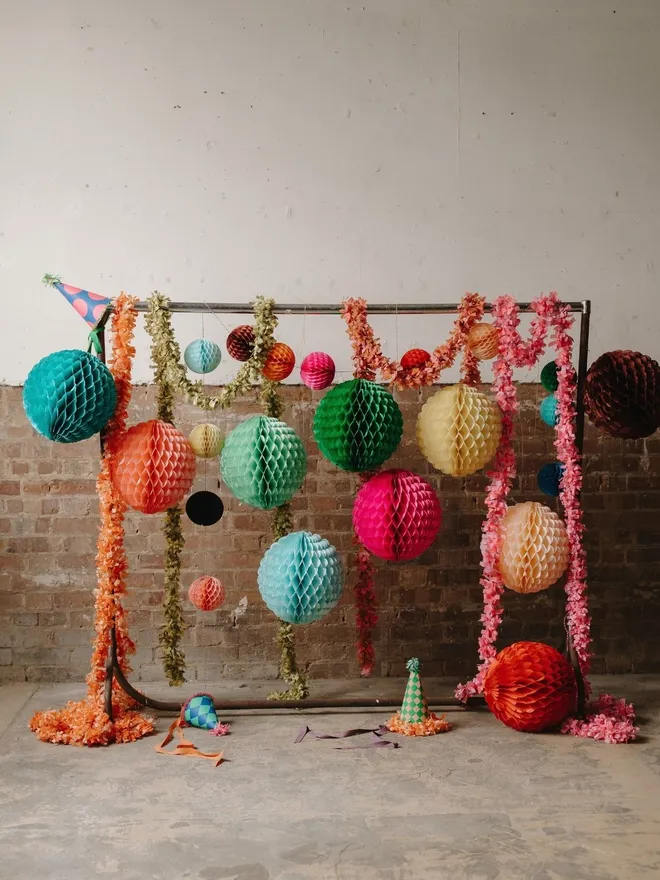Honeycomb paper decoartions hanging on a rail  
