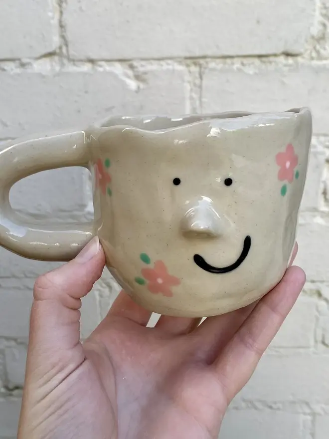 pink flower painted handmade ceramic smiley face mug