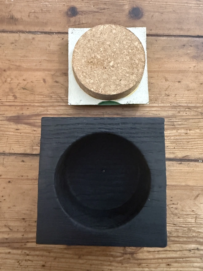 Empty black oak pot showing back of tile and cork stopper