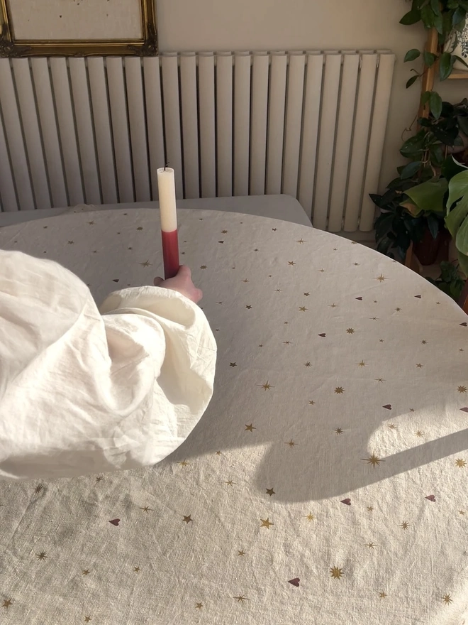 Astral Weeks Linen Tablecloth, a white and yellow table cloth sitting on a table. 