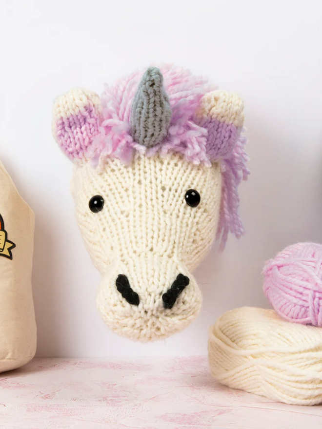 Unicorn Head Knitting Kit. A giant unicorn head in cream and lilac.