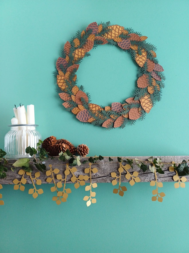 Gold Berry Garland displayed on mantelpiece underneath paper pinecone wreath