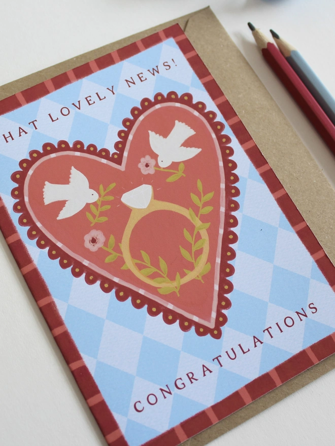 botanical engagement card featuring love birds on a big heart with a ring