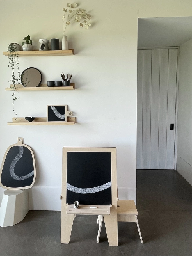 board in family space with Arty easel and shelves