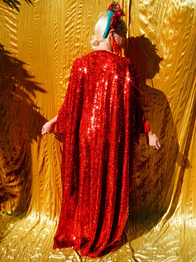 Red Holographic Sequin V-neck Kaftan Gown seen from the back.
