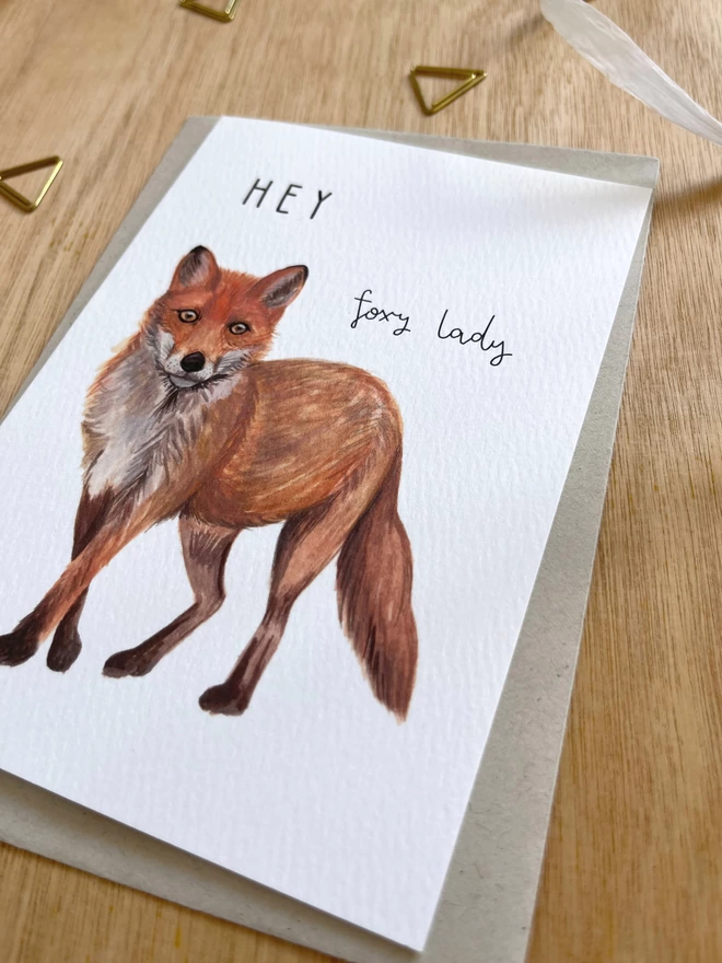 a greetings card featuring a fox illustration and the text “hey foxy lady”