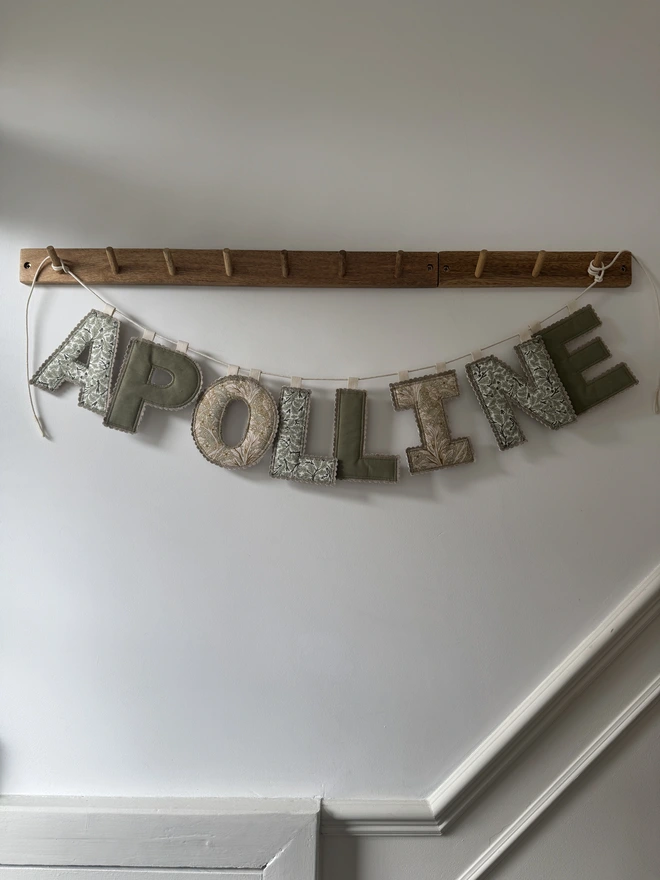 Fabric Letter Garland.  Multicoloured floral fabrics in letter form hung on a p il