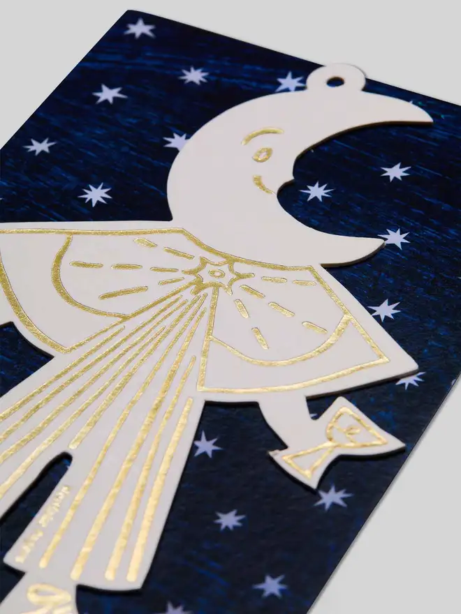 White and gold letterpress Moon Folk Ornament with starry blue packaging 