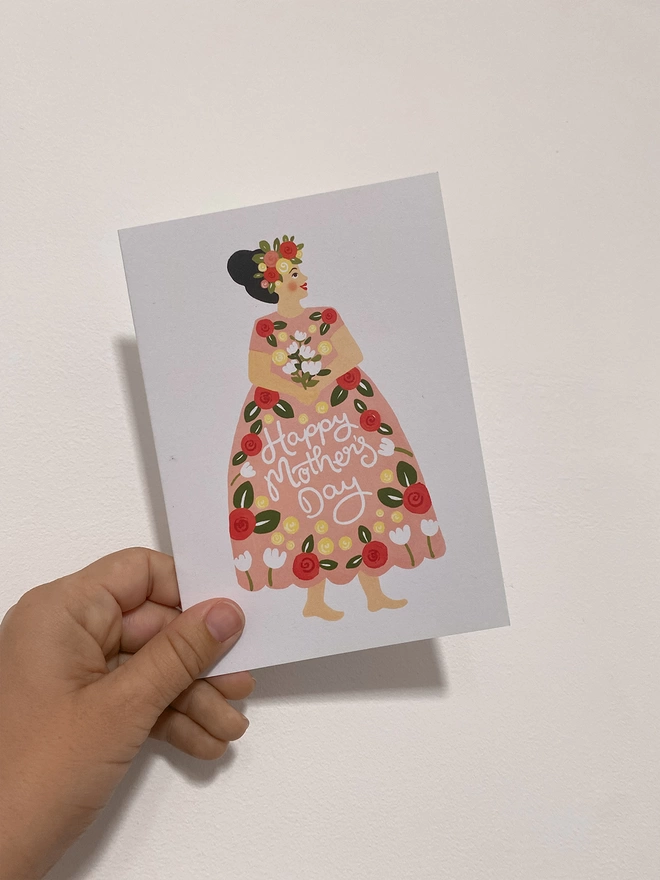 pink dress mothers day card in hand