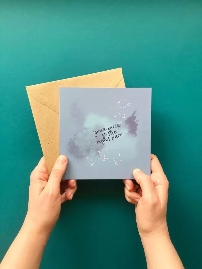 'Your Pace Is The Right Pace' Encouragement Card seen with a brown envelope held by a hand.