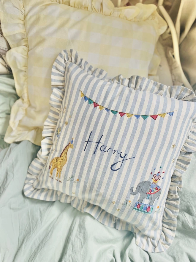 Hand Painted Giragge and ELephant celebrating the joy of the circus. Blue striped ruffle cushion with hand embroidered personalised name in the centre