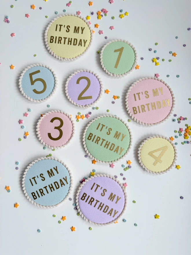 Pastel colour birthday number and It's My Birthday badges with a pompom trim 