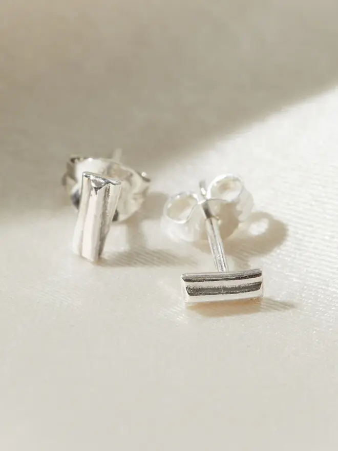 Close up image Silver Ripple Stud Earrings showing the clasps