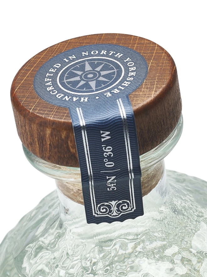 Navy Strength Gin, a bottle of gin sitting on a white plain surface