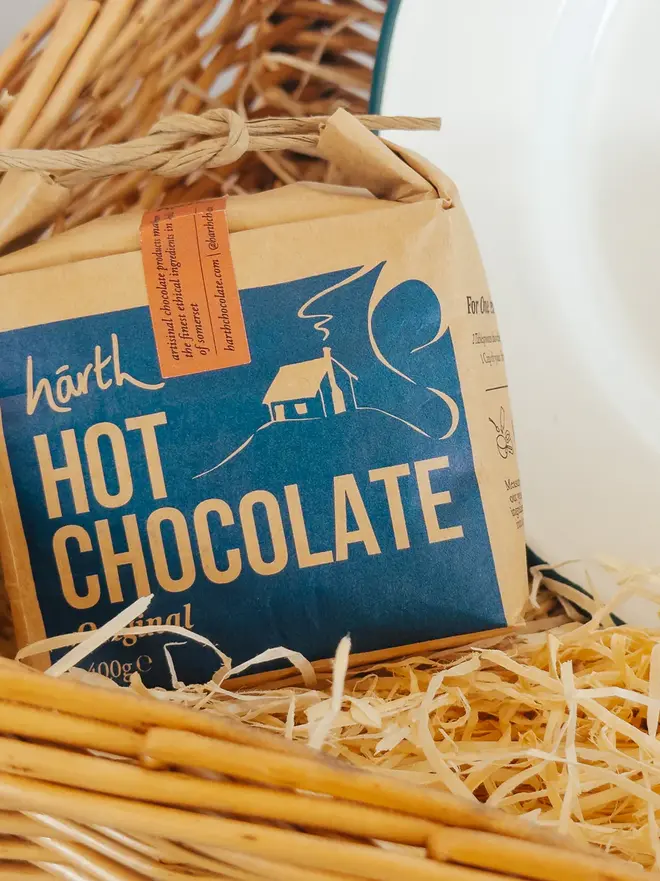 willow complete picnic hamper. a bag of hot chocolate powder inside a willow picnic basket.