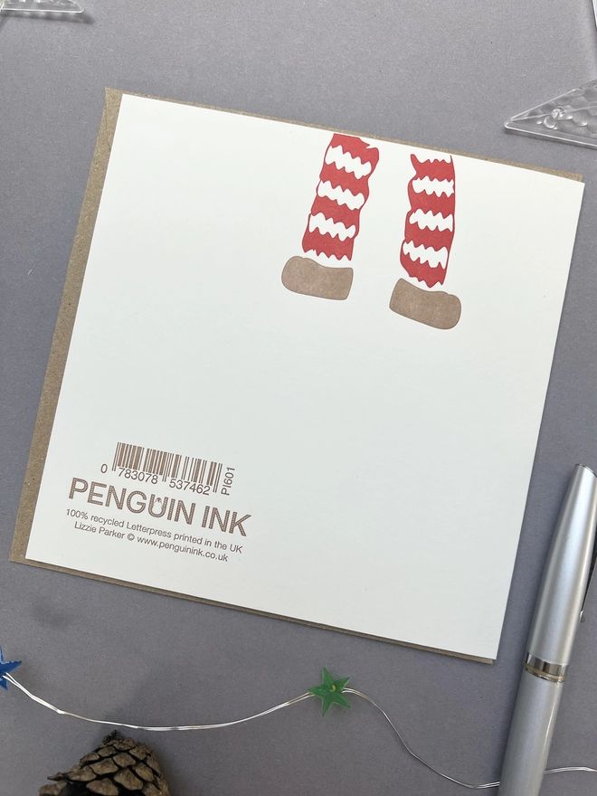 Back of the card with legs dangling from the top and the logo and barcode at the bottom