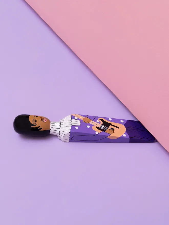 Wooden Door Stopper (The Purple One), a colourful wooden door stop sitting under a door.