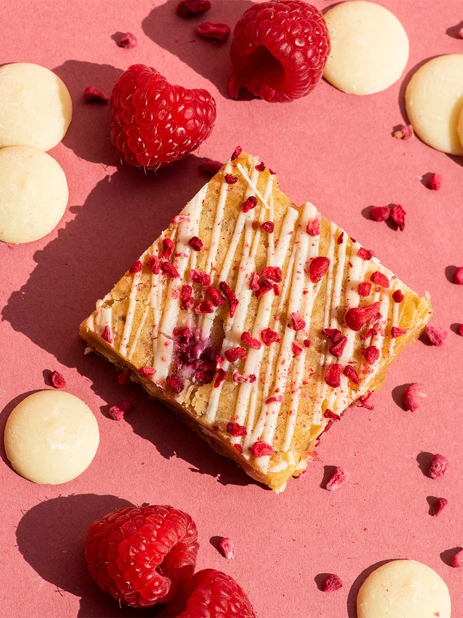 Valentine’s Brownie Selection (Box Of 6, 12, 16 Or 32), brownie sitting together on a pink surface. 