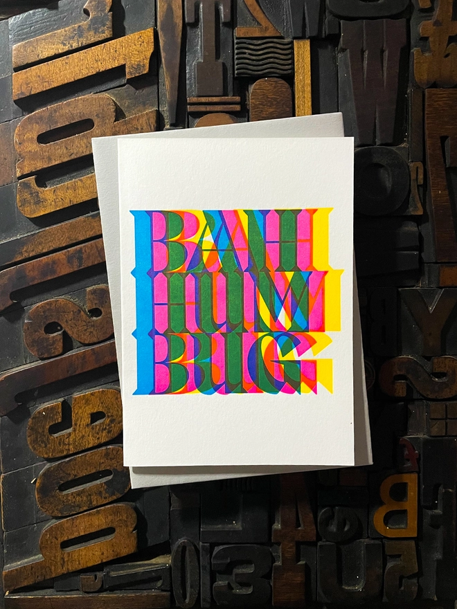 Bah Humbug! A beautiful typographic letterpress Christmas card set. Printed with rich vibrant and fluorescent blue, magenta and yellow inks with luxury matching and contrasting envelopes; ideal to send to your designer friends.