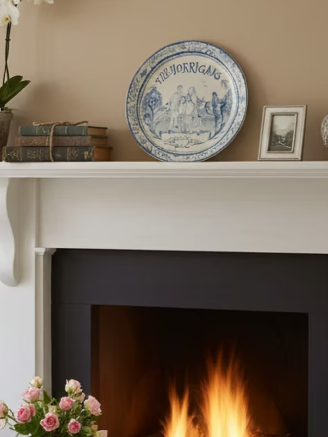 personalised family portrait round platter. a personalised family portrait plate on a mantelpiece.