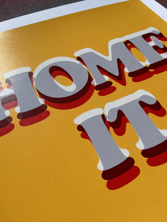 "Home it" Hand pulled Screen Print with layered typography on a deep yellow back ground that has “home it” printed on top in layered typography 
