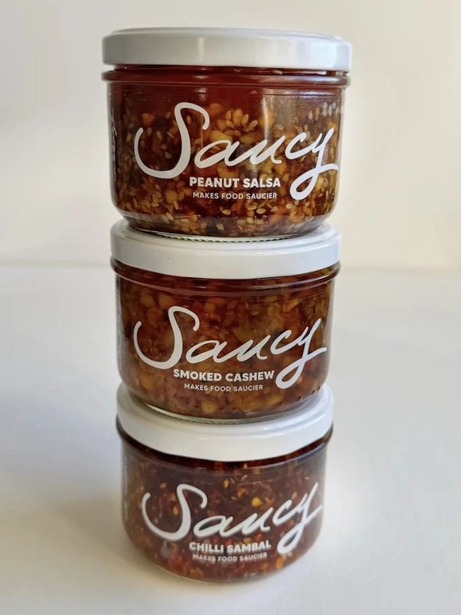 The Saucy Trio (Set Of 3), a trio of sauces sitting on a white table against a grey backdrop. 