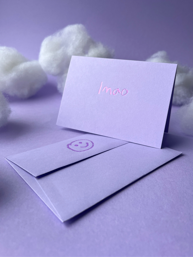 lavender coloured card with lmao  short for 'laugh my ass off' hand foiled in kids hand writing