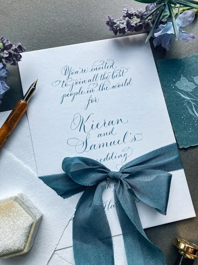 bespoke calligraphy wedding invitations. white paper invitations with black calligraphy.