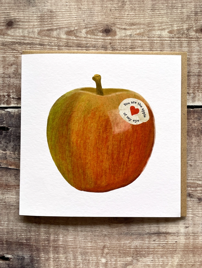 Illustrated greetings card featuring an apple with the words you are the apple of my eye, blank inside.