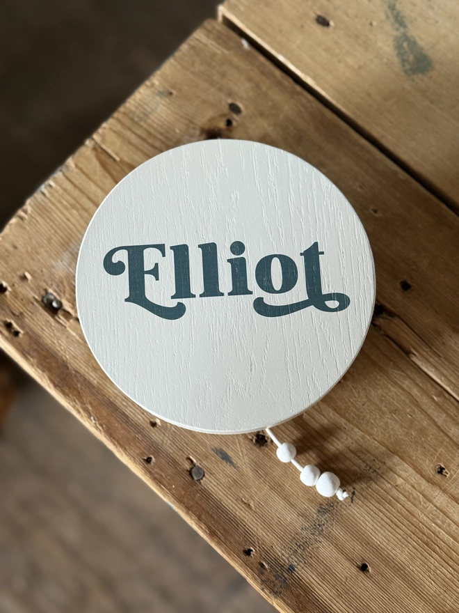 music box that hangs on a wall with a name on it