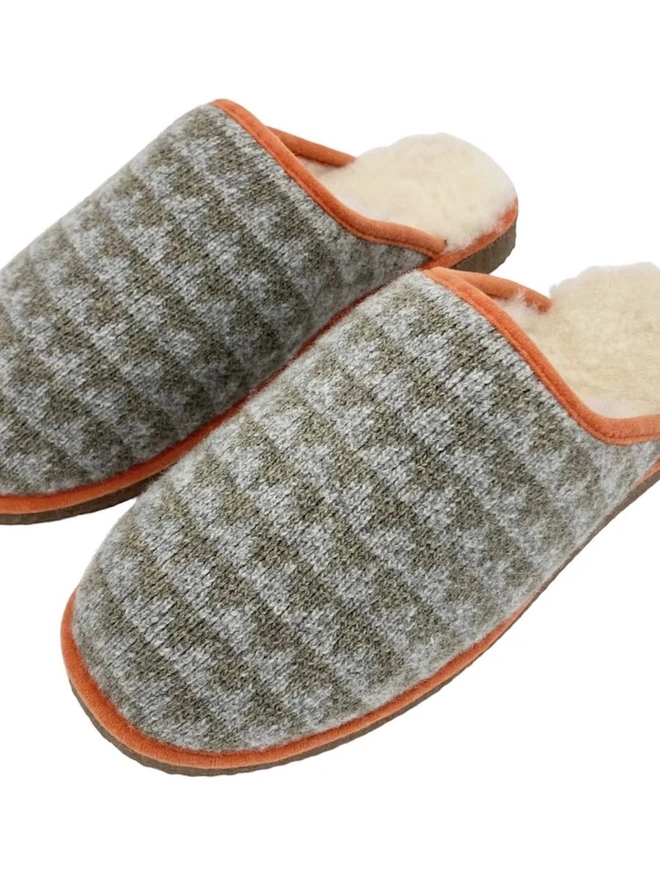 Lambswool & Sheepskin Slippers, a pair of colourful lambswool and sheepskin slippers sitting on a plain white surface. 