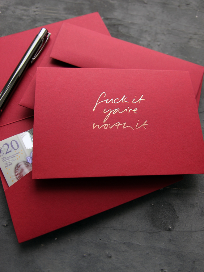 Fuck It You're Worth It cash card in scarlet with rose gold foil and matching envelope