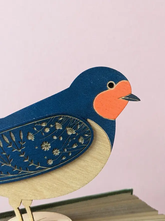 Standing Wooden Barn Swallow, blue wooden bird decoration standing on book. 