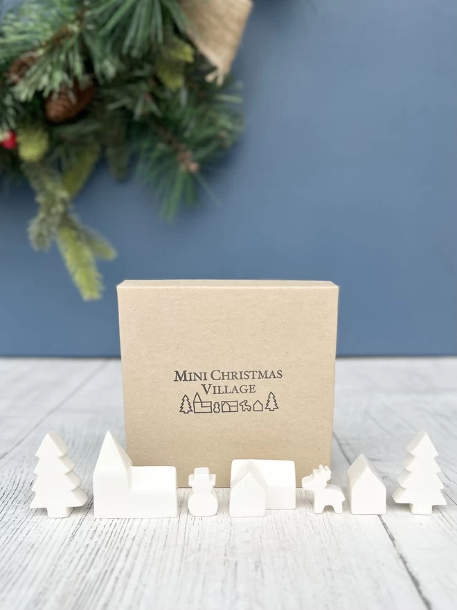  Mini church, house, cottage, snowman, deer and 2 Christmas trees made out of cream/white clay.