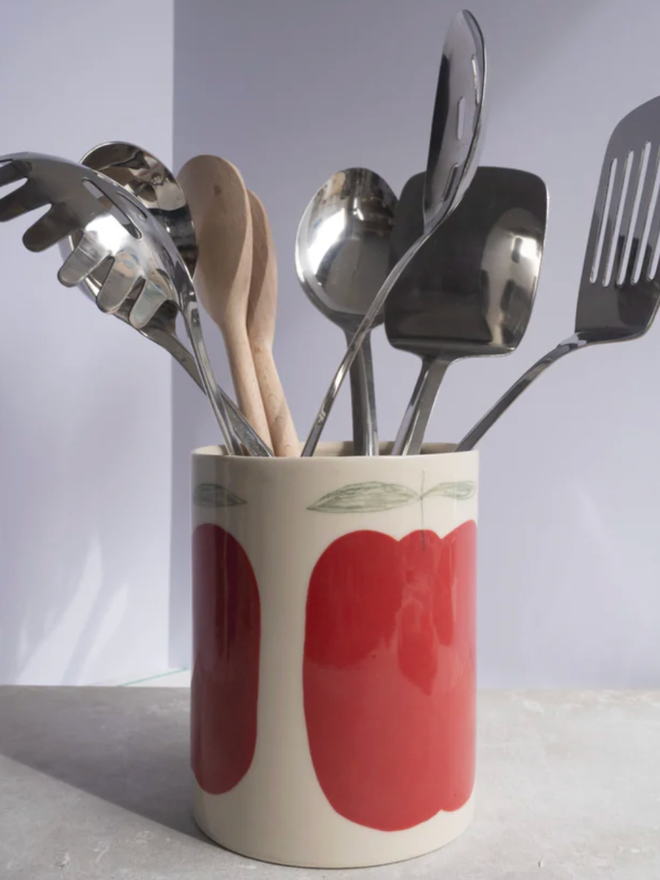Utensil Holder. A utensil holder with an apple design.