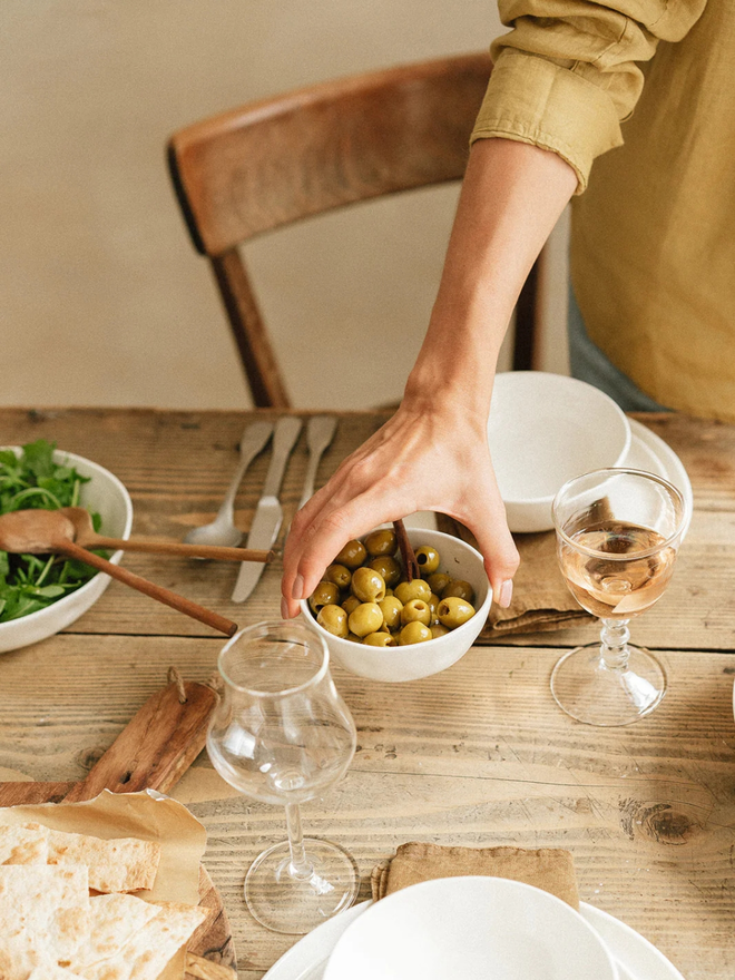 'milk' handcrafted stoneware bowl. a white serving bowl holding olives.